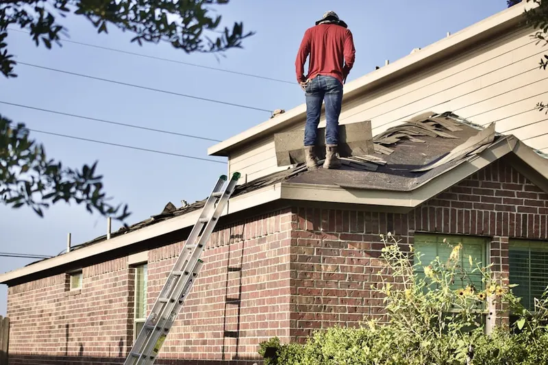 Professional roofer working on a residential roof in Ponakin Mill